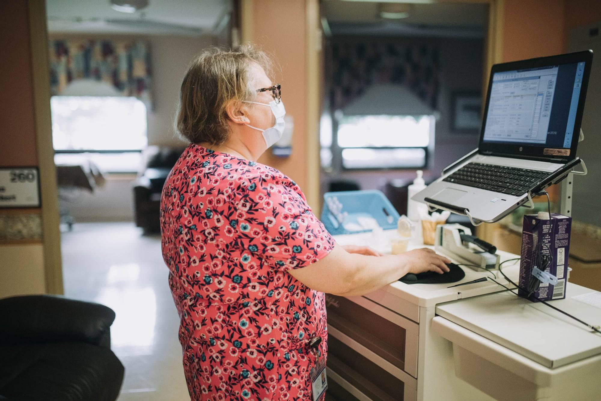 nurses aide working on computer