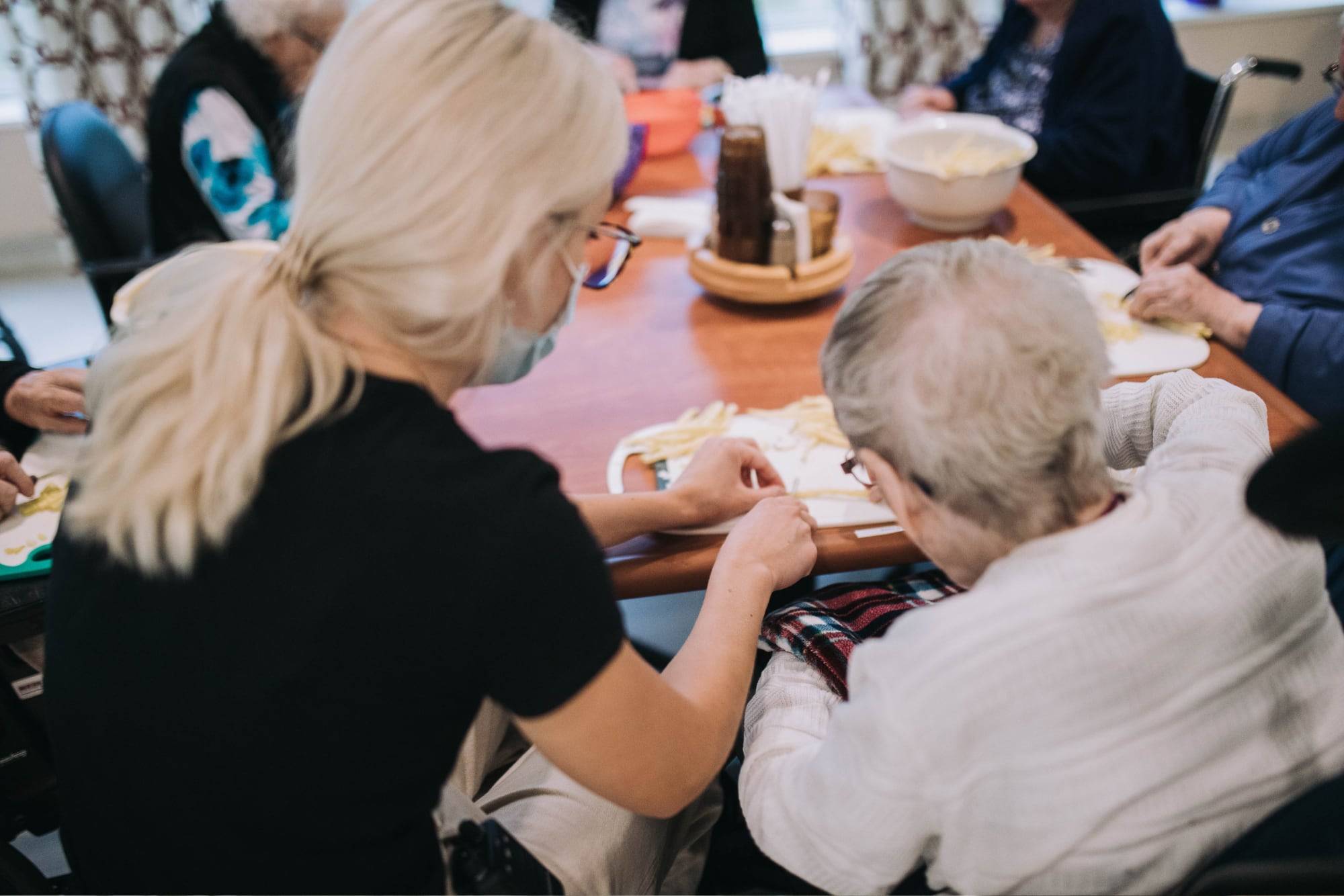 volunteer helping resident with meal prep